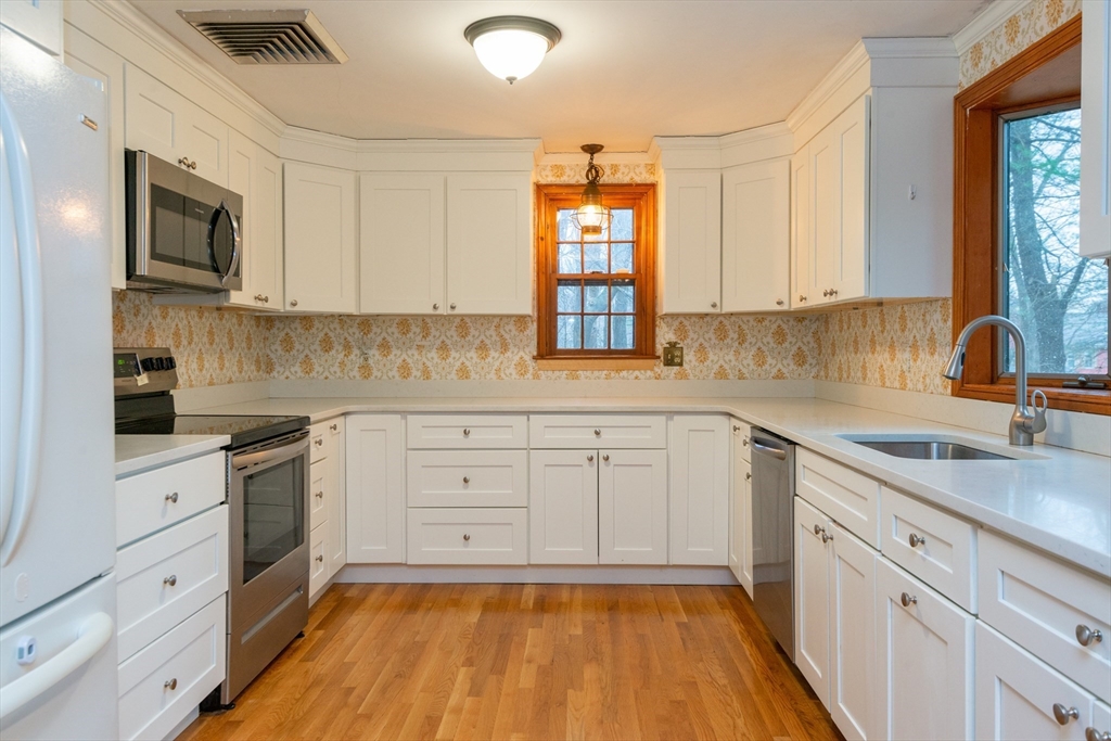 15 Hart Road Lynnfield, MA 01940 - Photo 9 of 40 a kitchen with a white cabinets sink and window