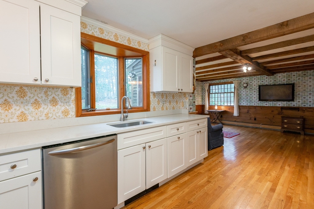 15 Hart Road Lynnfield, MA 01940 - Photo 10 of 40 a kitchen with stainless steel appliances granite countertop a sink and cabinets with wooden floor