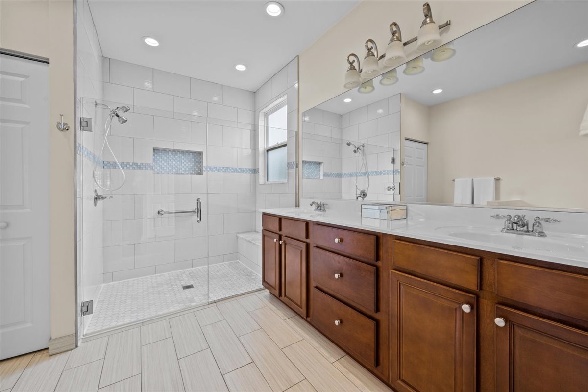 1090 Deerpath Road Aurora, IL 60506 - Photo 15 of 28 a spacious bathroom with a granite countertop sink mirror and shower
