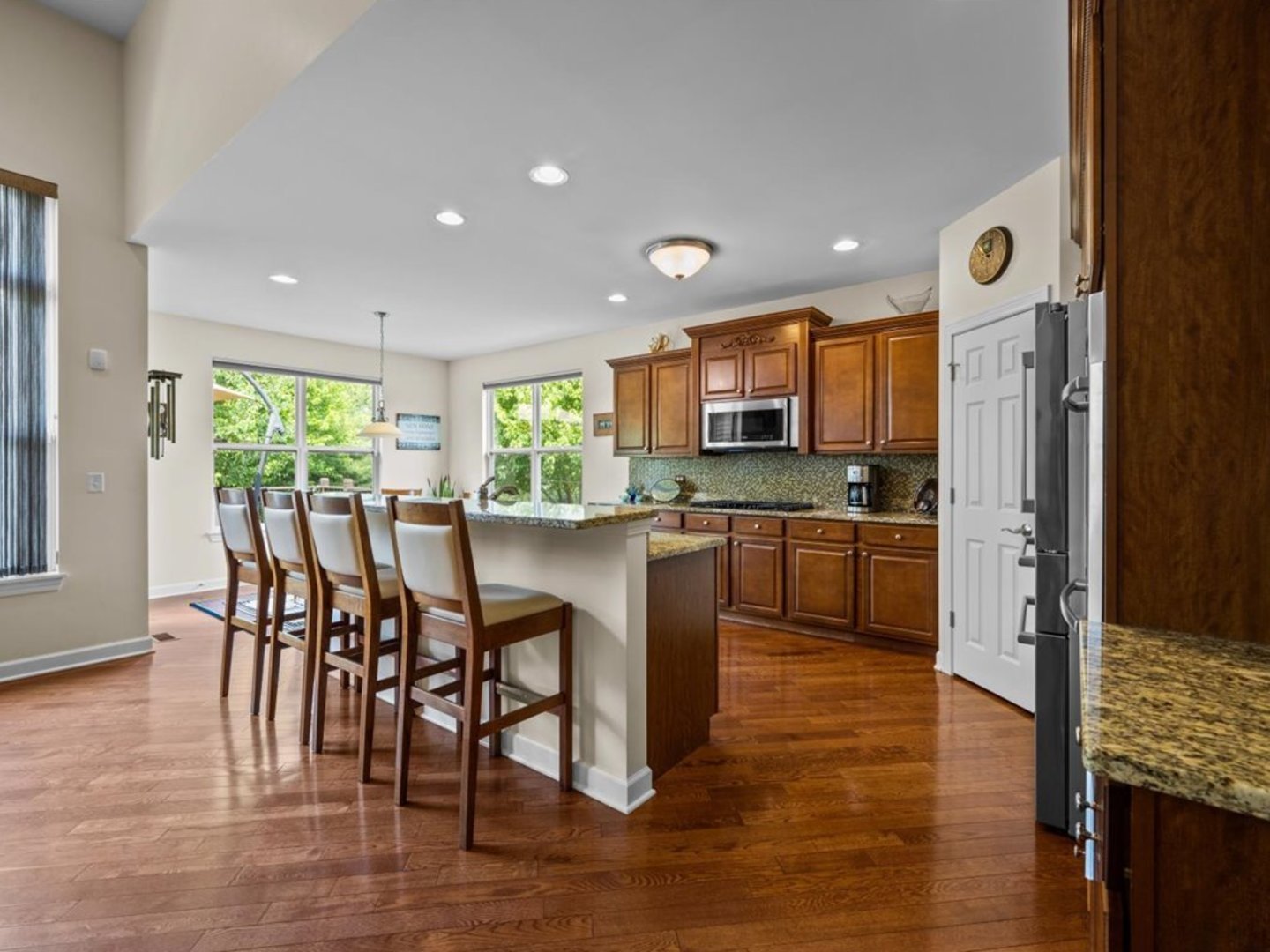 1090 Deerpath Road Aurora, IL 60506 - Photo 7 of 28 a kitchen with a table chairs refrigerator microwave and cabinets
