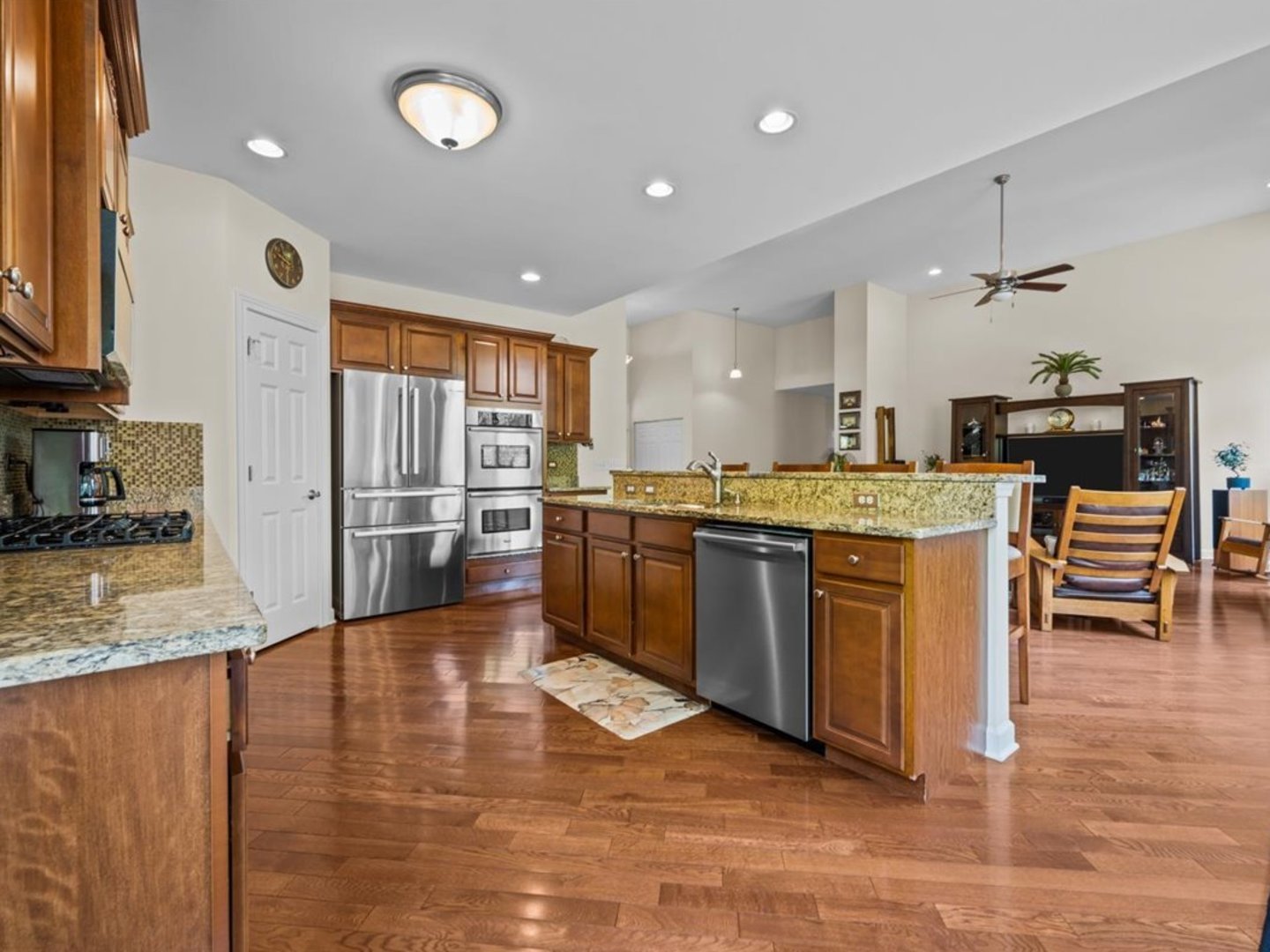 1090 Deerpath Road Aurora, IL 60506 - Photo 10 of 28 a kitchen with stainless steel appliances granite countertop a stove a sink dishwasher and a refrigerator with wooden floor