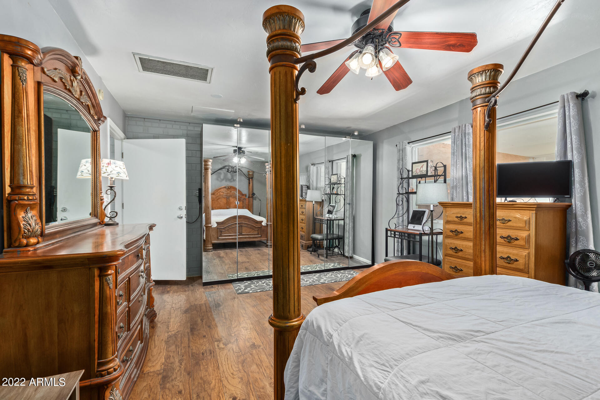 7201 North 16th Drive Phoenix, AZ 85021 - Photo 12 of 29 a bedroom with a bed and a flat tv screen on dresser