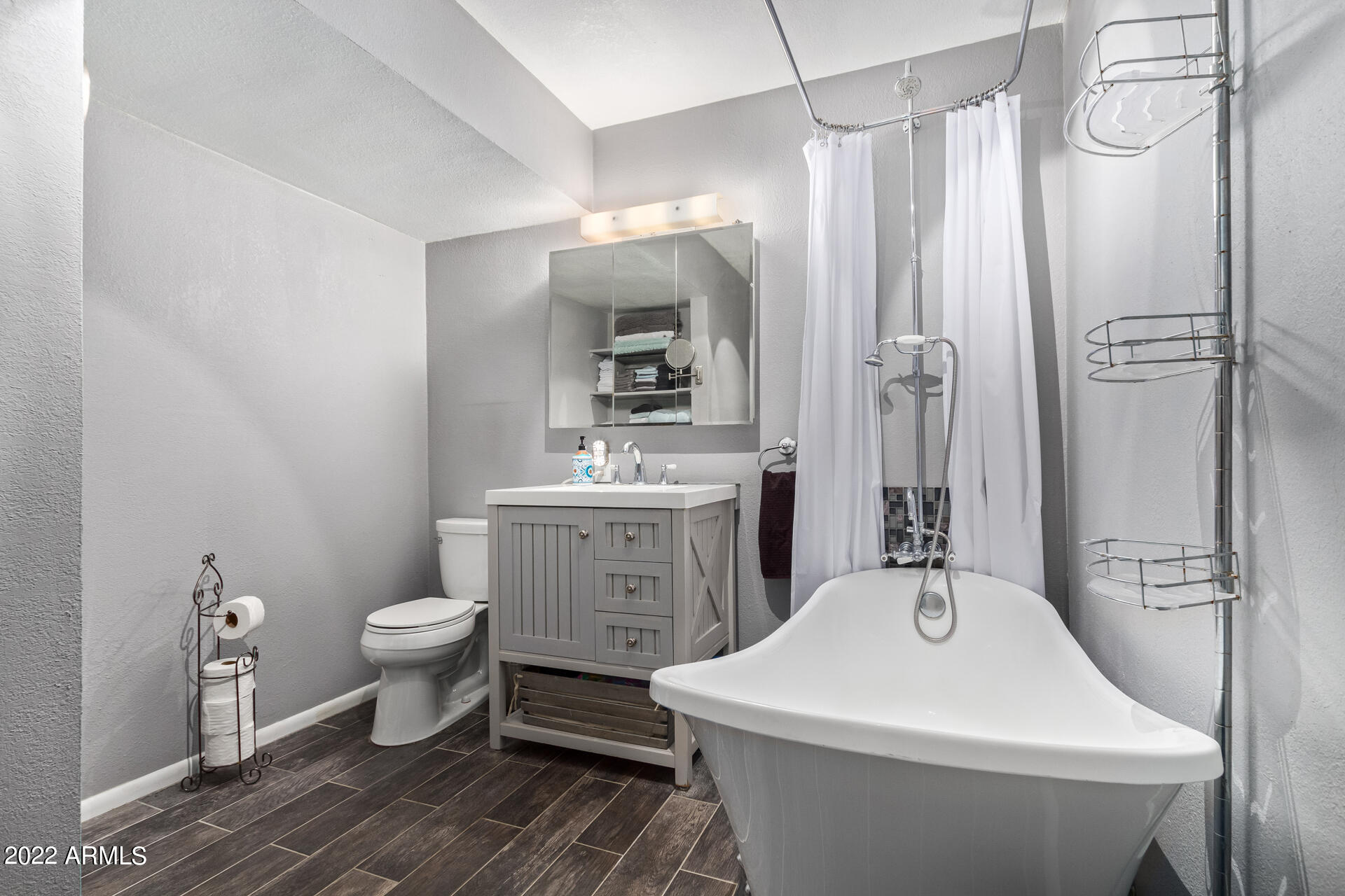 7201 North 16th Drive Phoenix, AZ 85021 - Photo 14 of 29 a bathroom with a sink toilet a mirror and shower