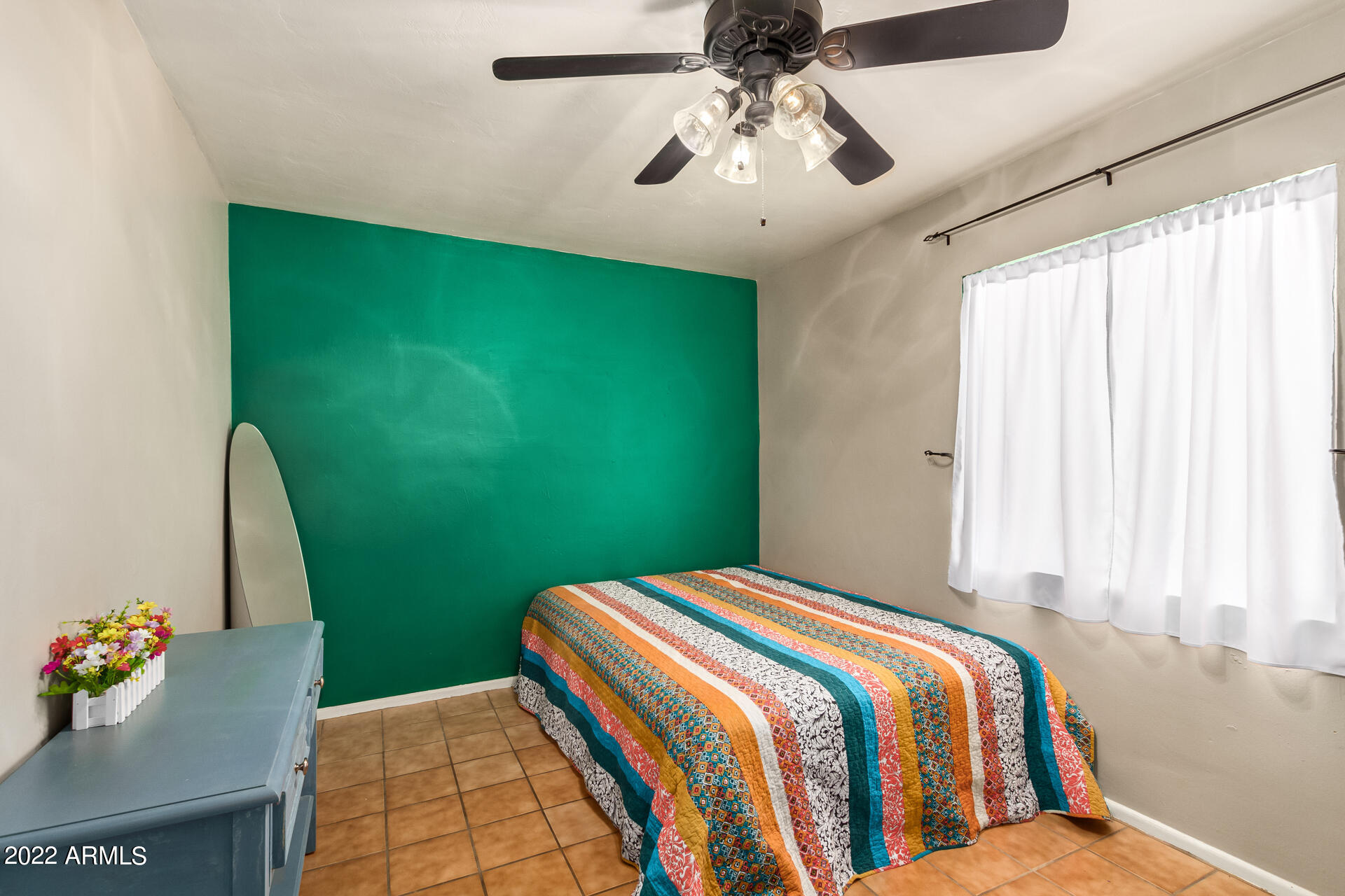 7201 North 16th Drive Phoenix, AZ 85021 - Photo 17 of 29 a bedroom with a bed and a chandelier