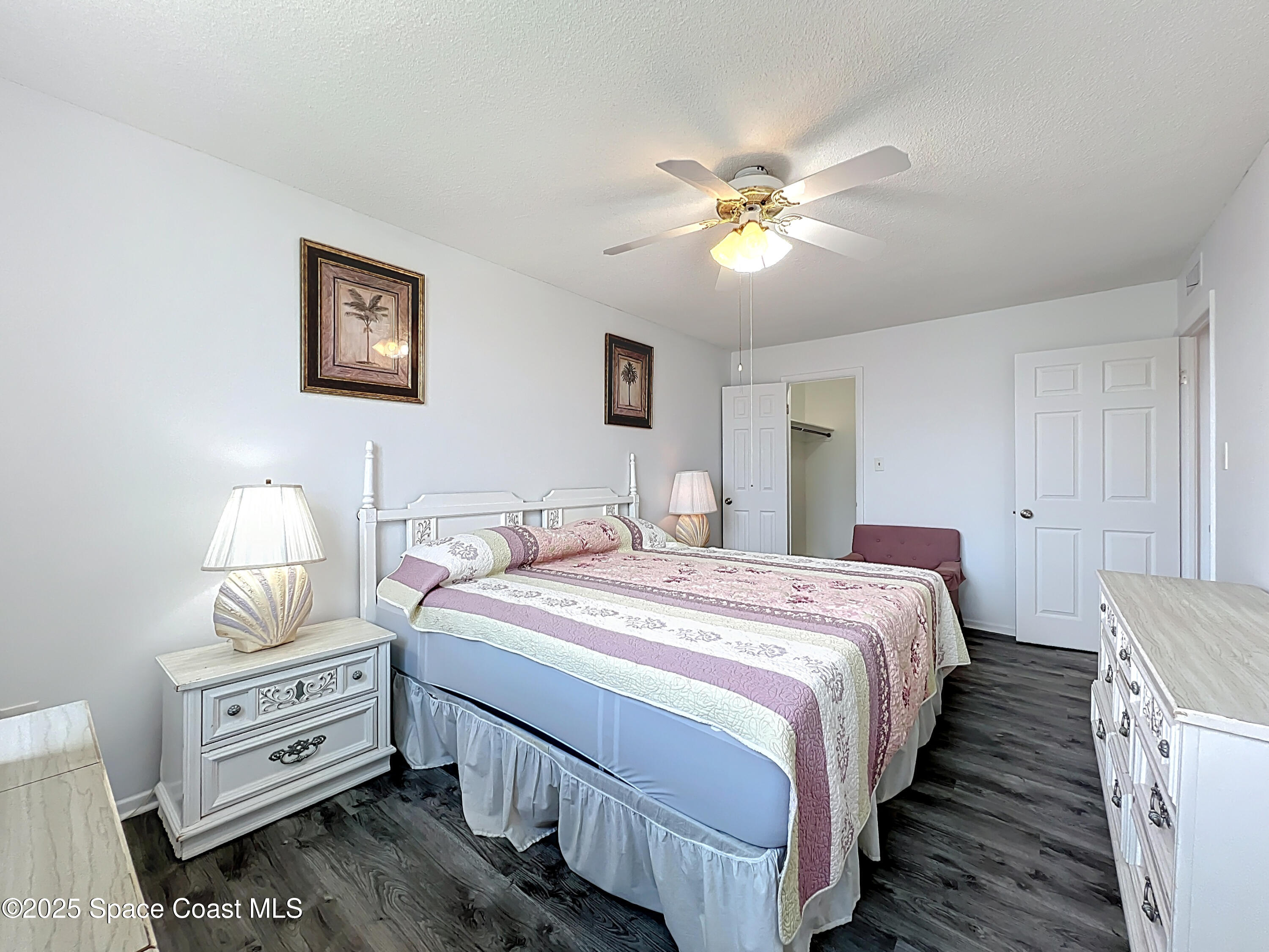 2020 North Atlantic Avenue, Unit 514N Cocoa Beach, FL 32931 - Photo 14 of 31 a bedroom with bed and a chandelier