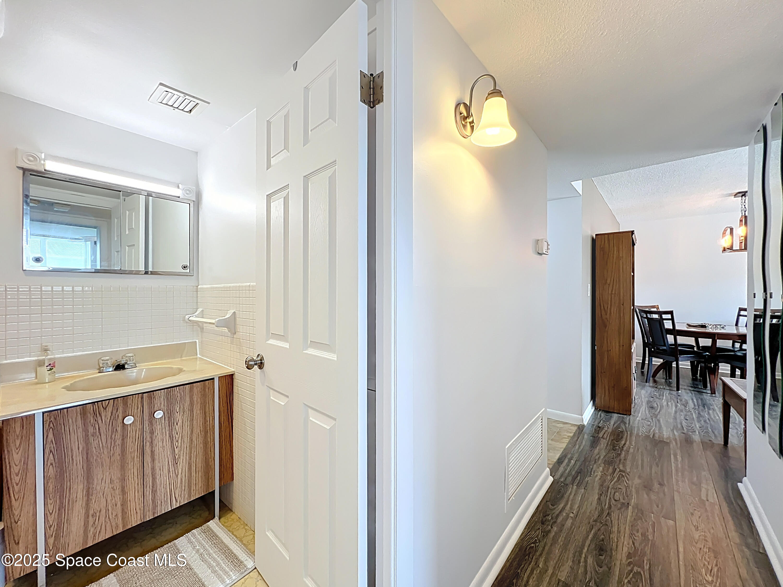 2020 North Atlantic Avenue, Unit 514N Cocoa Beach, FL 32931 - Photo 15 of 31 a bathroom with a sink a mirror and a window