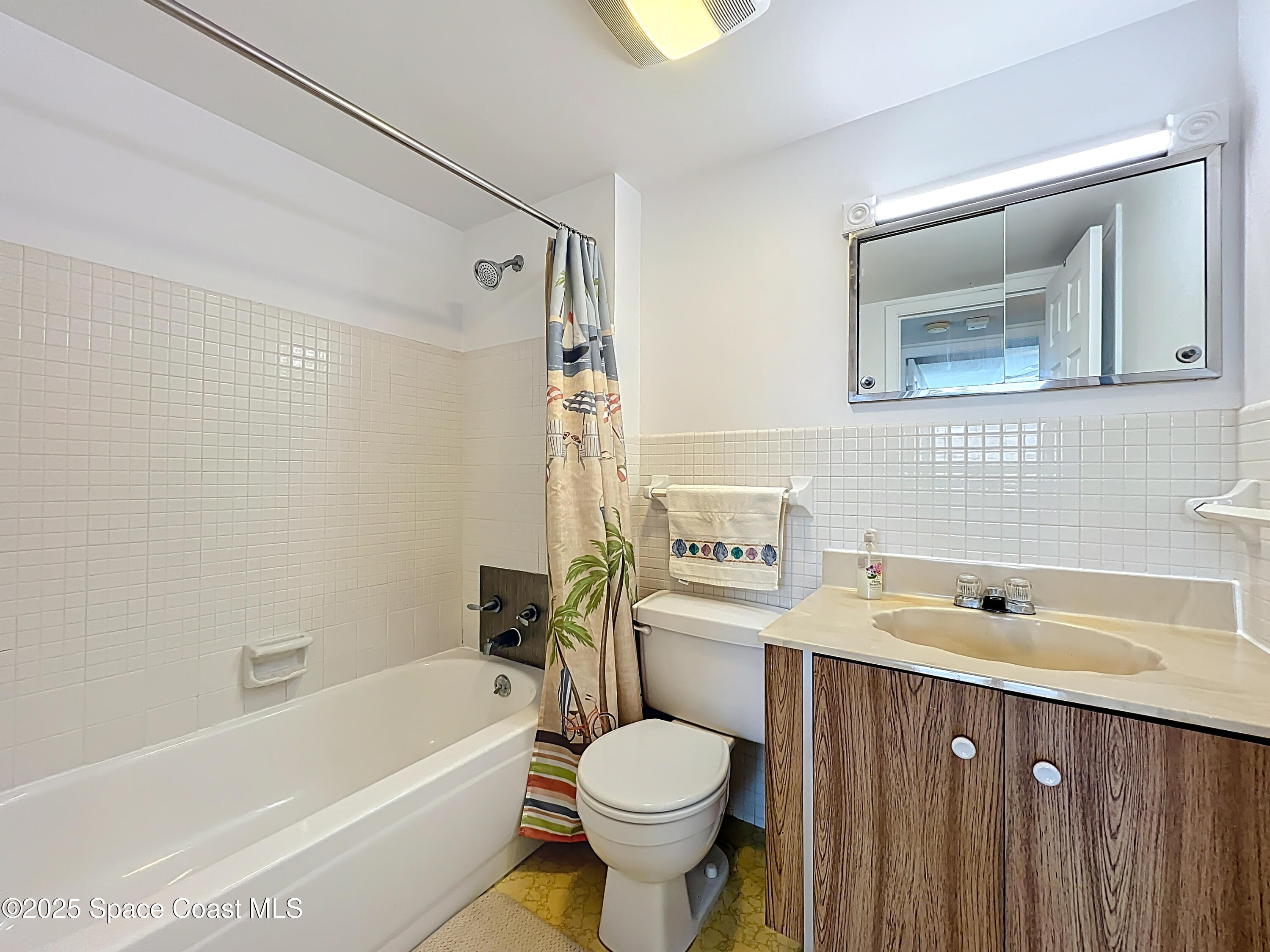 2020 North Atlantic Avenue, Unit 514N Cocoa Beach, FL 32931 - Photo 16 of 31 a bathroom with a sink toilet and shower