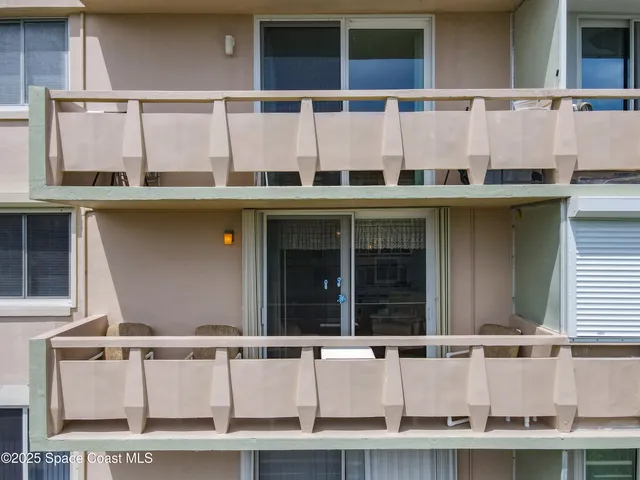 a large building with a large window and balcony