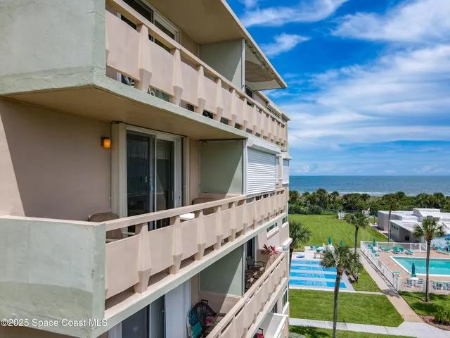 a view of swimming pool with outdoor seating and yard in back