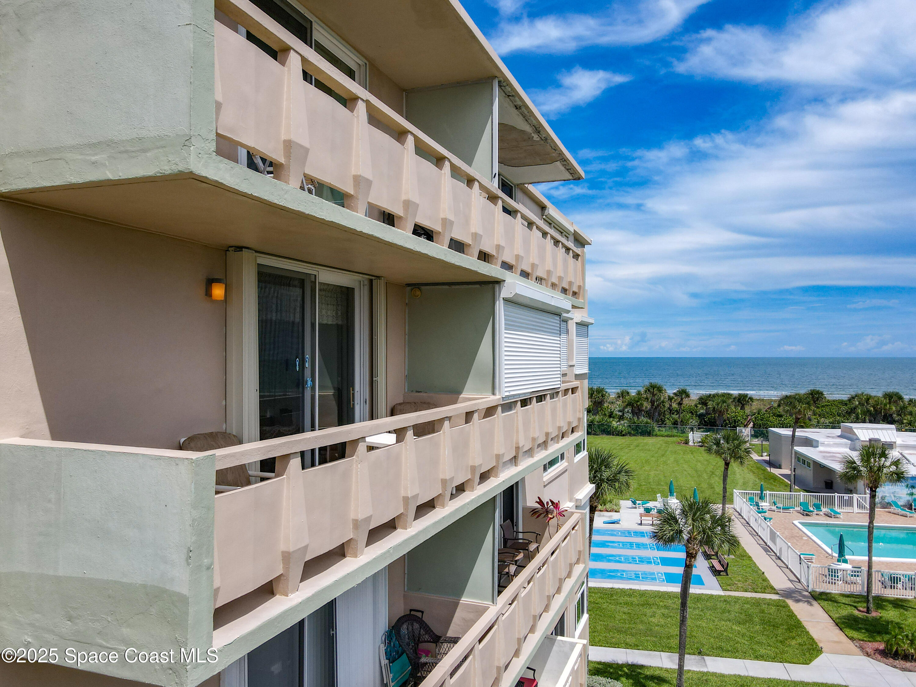 2020 North Atlantic Avenue, Unit 514N Cocoa Beach, FL 32931 - Photo 22 of 31 a large building with a large window and balcony
