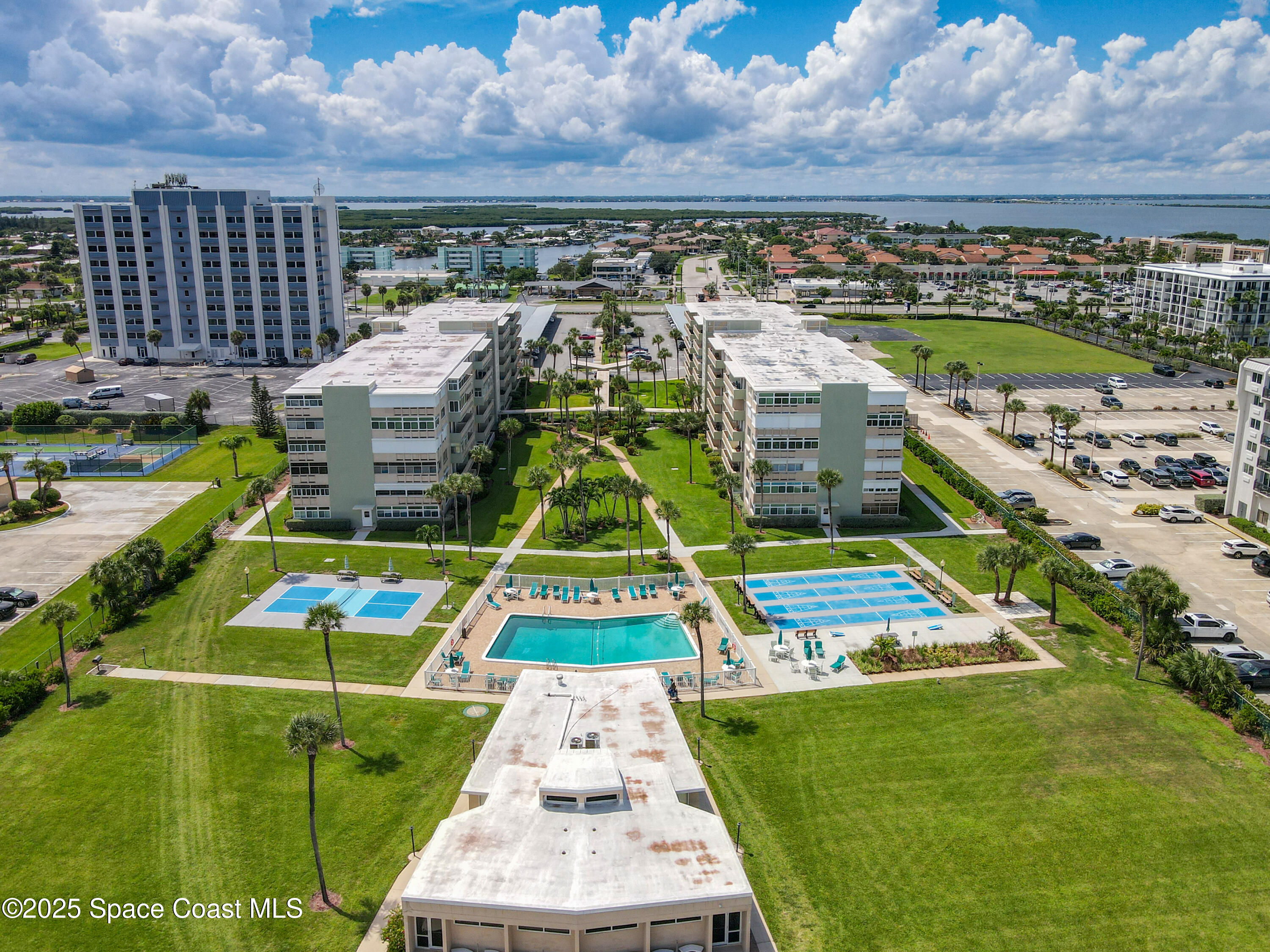 2020 North Atlantic Avenue, Unit 514N Cocoa Beach, FL 32931 - Photo 23 of 31 a view of swimming pool with outdoor seating and yard in back