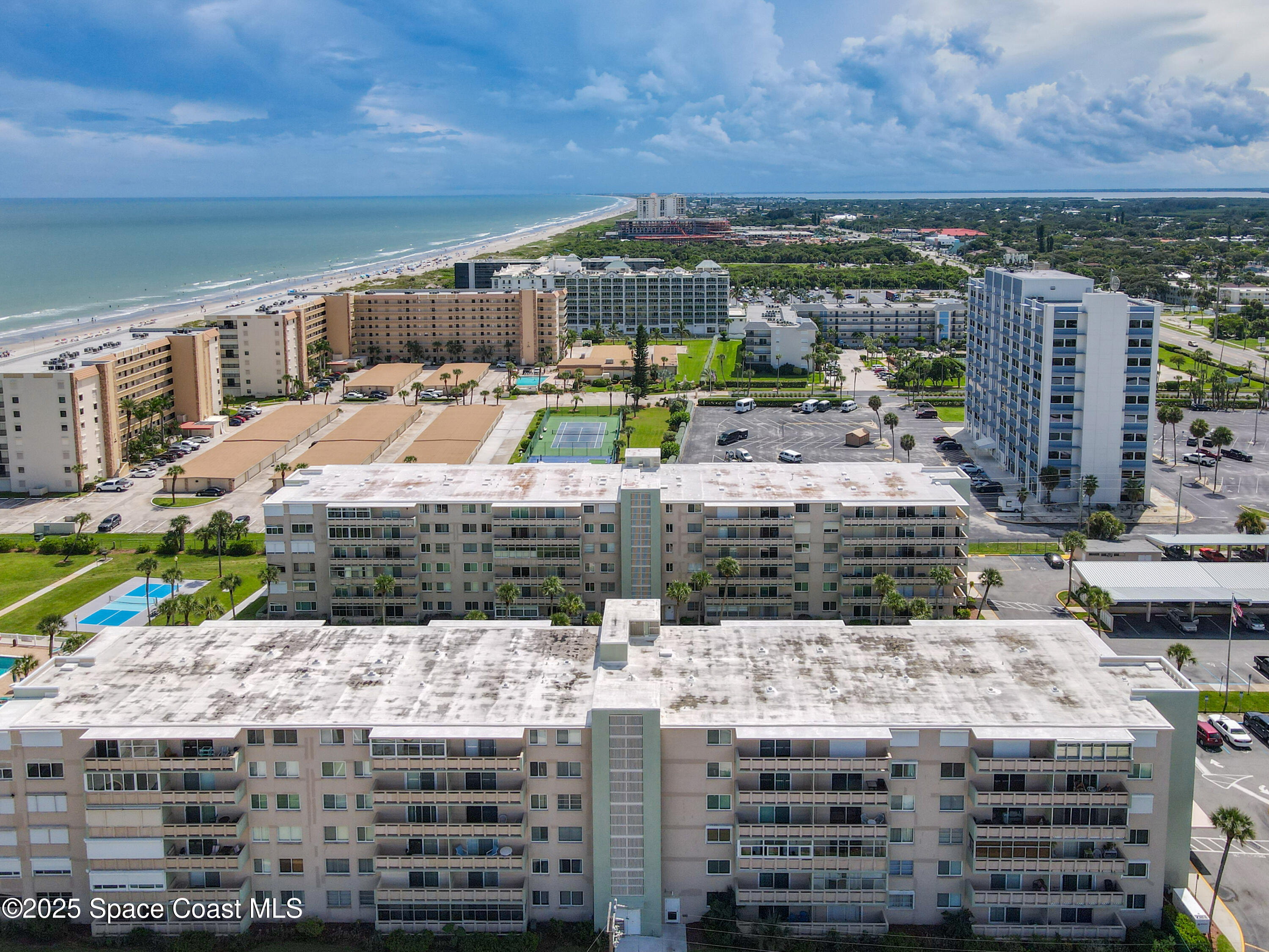 2020 North Atlantic Avenue, Unit 514N Cocoa Beach, FL 32931 - Photo 24 of 31 a view of a balcony with a yard and potted plants