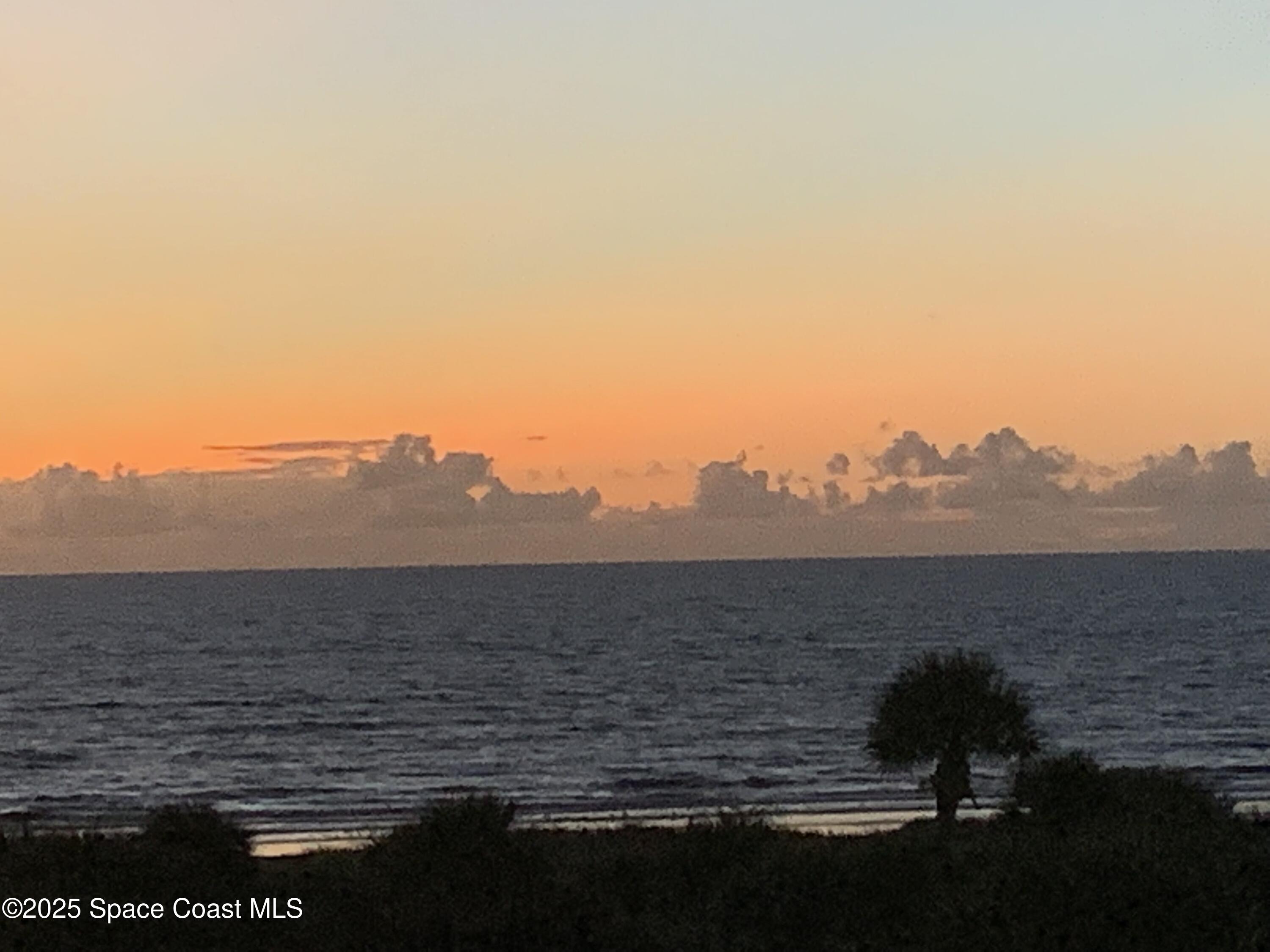 2020 North Atlantic Avenue, Unit 514N Cocoa Beach, FL 32931 - Photo 28 of 31 a view of ocean with sunset