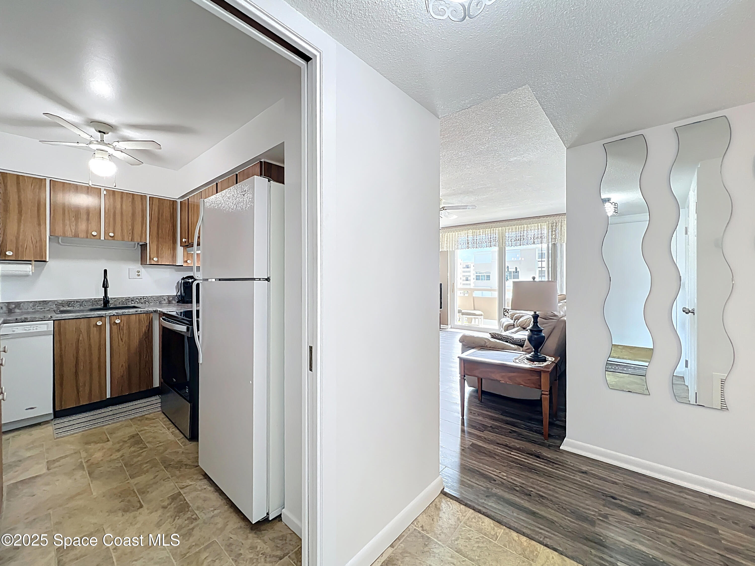 2020 North Atlantic Avenue, Unit 514N Cocoa Beach, FL 32931 - Photo 4 of 31 a kitchen with stainless steel appliances a refrigerator and a stove top oven