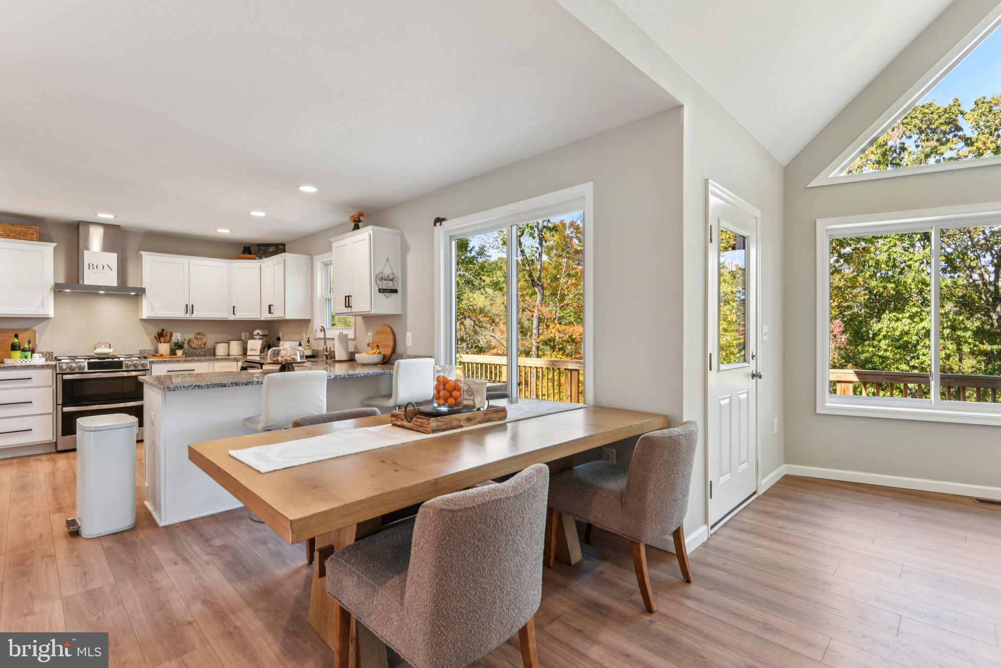 490 Black Twig Road Linden, VA 22642 - Photo 15 of 67 a kitchen with a table chairs stove a sink dishwasher and cabinets with wooden floor