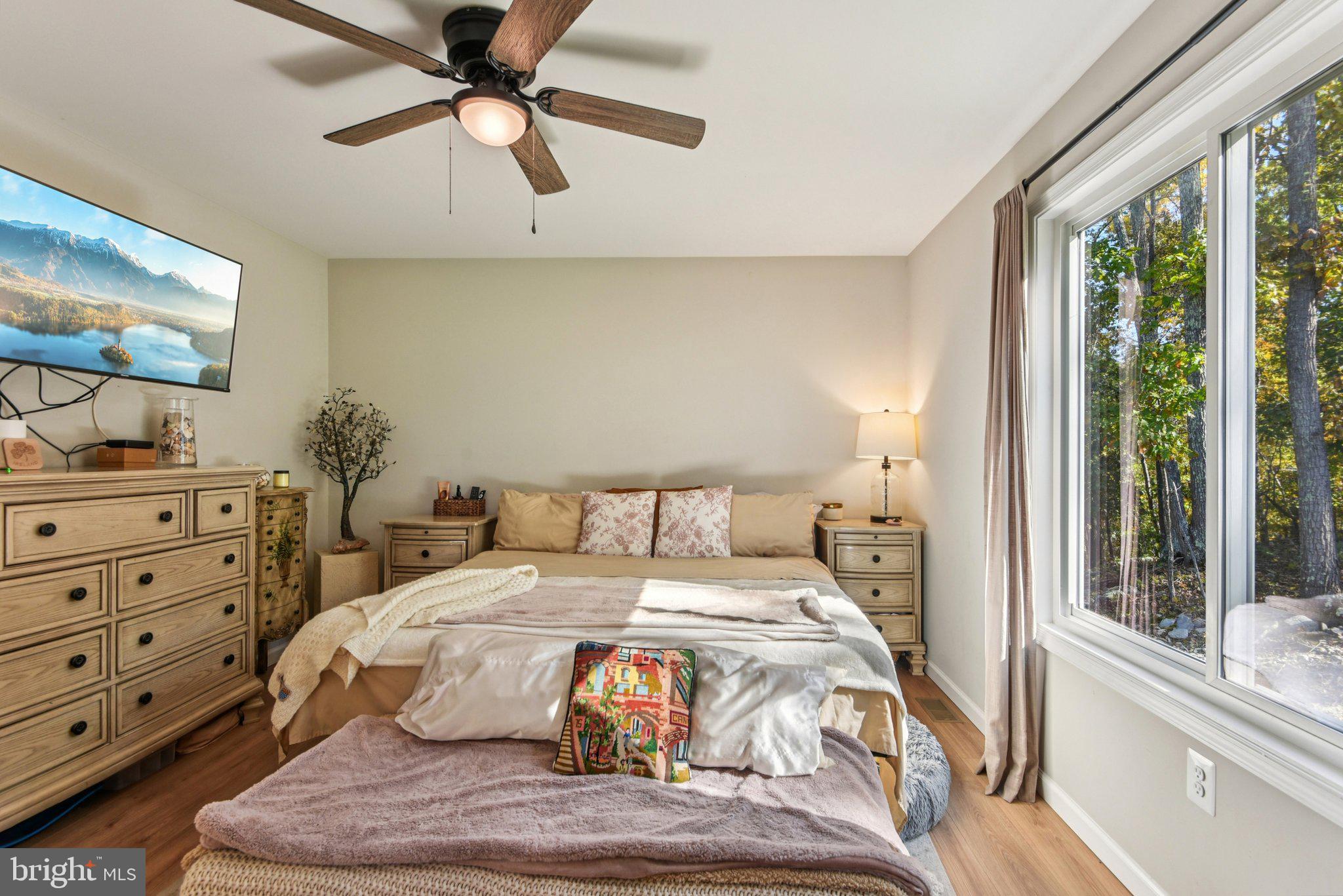 490 Black Twig Road Linden, VA 22642 - Photo 24 of 67 a bedroom with a bed and large windows