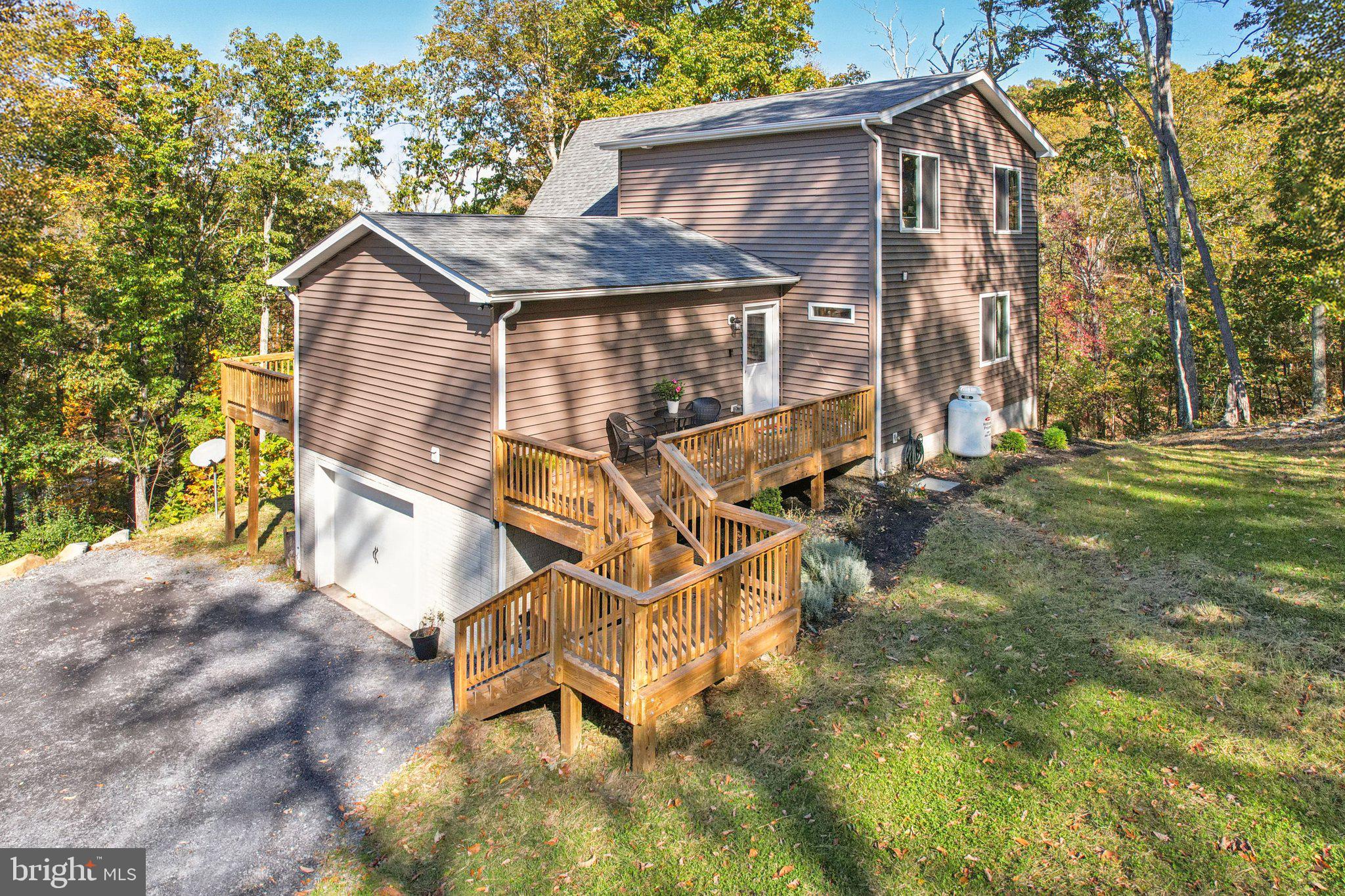 490 Black Twig Road Linden, VA 22642 - Photo 42 of 67 a backyard of a house with table and chairs