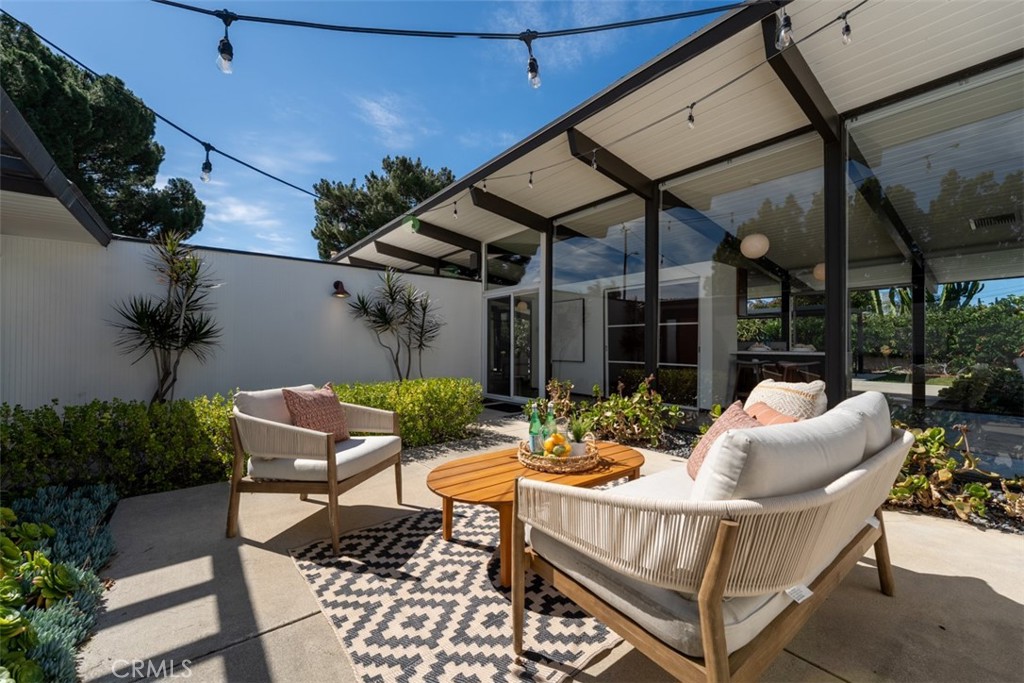 1830 North Ridgewood Street Orange, CA 92865 - Photo 12 of 29 a view of a patio with a table and chairs and potted plants