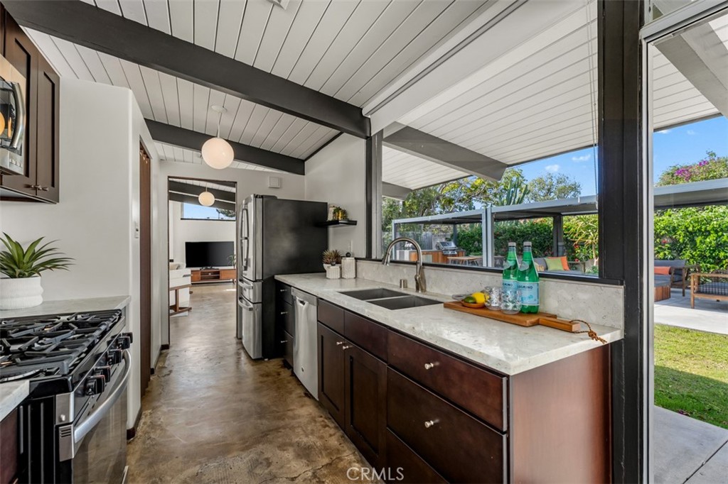 1830 North Ridgewood Street Orange, CA 92865 - Photo 14 of 29 a kitchen with a sink stove and cabinets