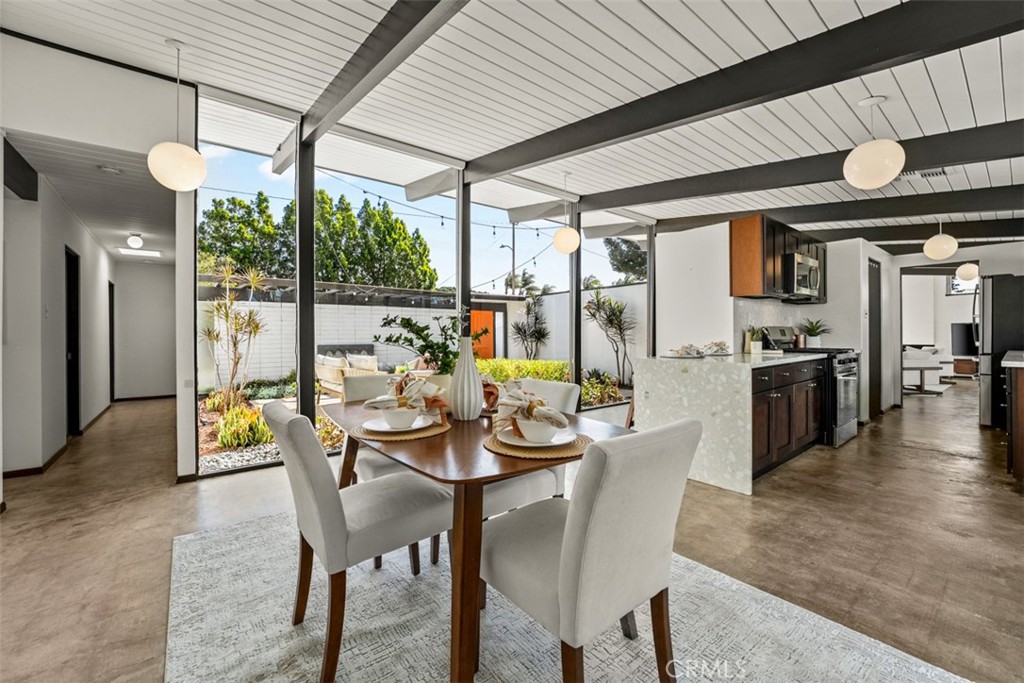 1830 North Ridgewood Street Orange, CA 92865 - Photo 2 of 29 a dining room with furniture a chandelier and wooden floor