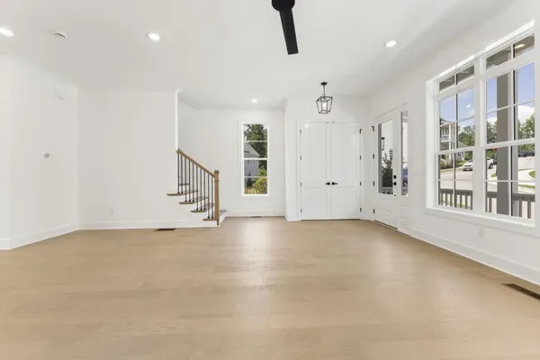 a view of entryway and hall with wooden floor