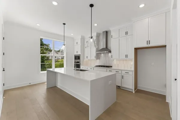 a view of a small space with wooden floor and a ceiling fan