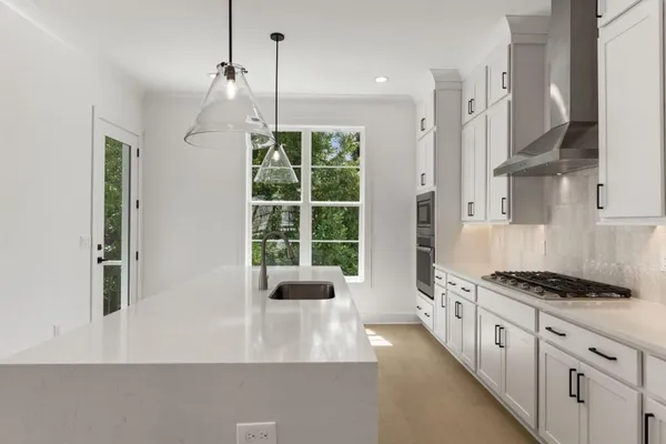 a bathroom with a granite countertop double vanity sink and a mirror