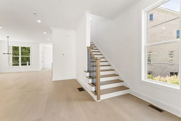 an empty room with cabinet and mirrors