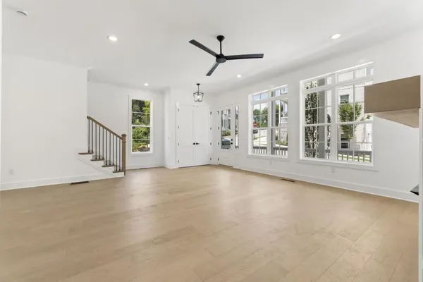 a view of an empty room with a fireplace and a window