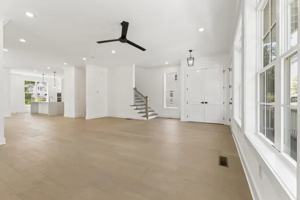 a view of an empty room with a fireplace and a window