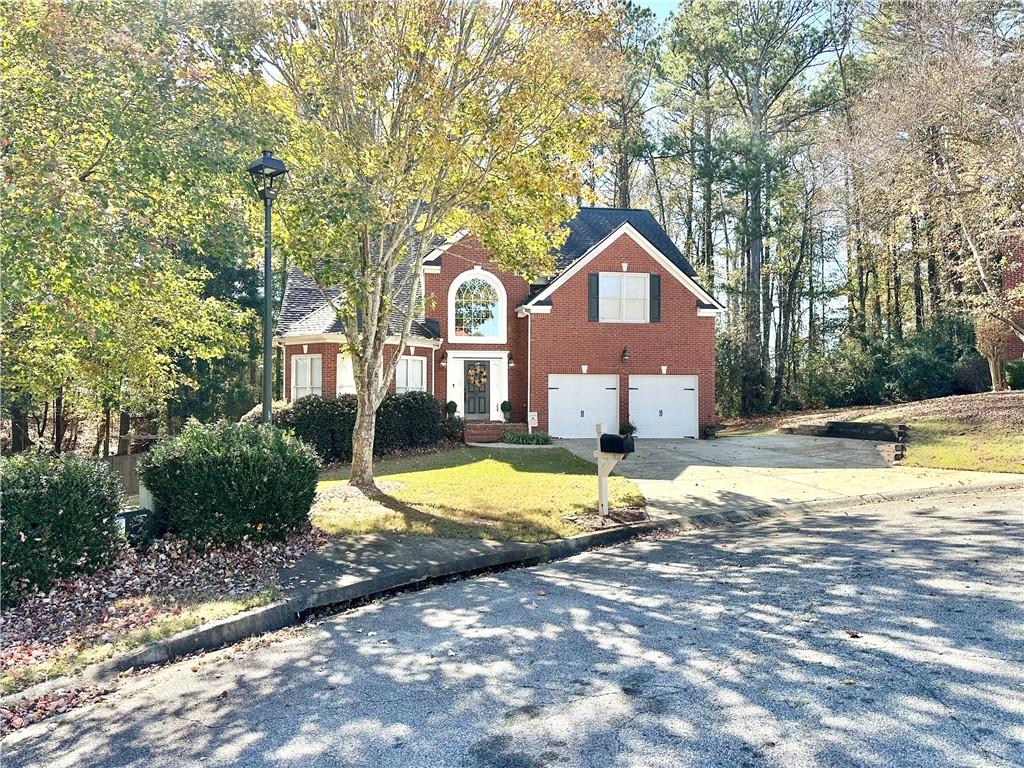 a house that has a tree in front of it