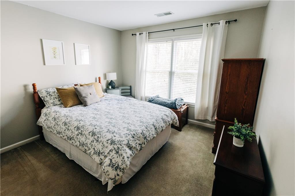 2533 Gold Hill Court Villa Rica, GA 30180 - Photo 31 of 46 a bed sitting in a bedroom next to a window