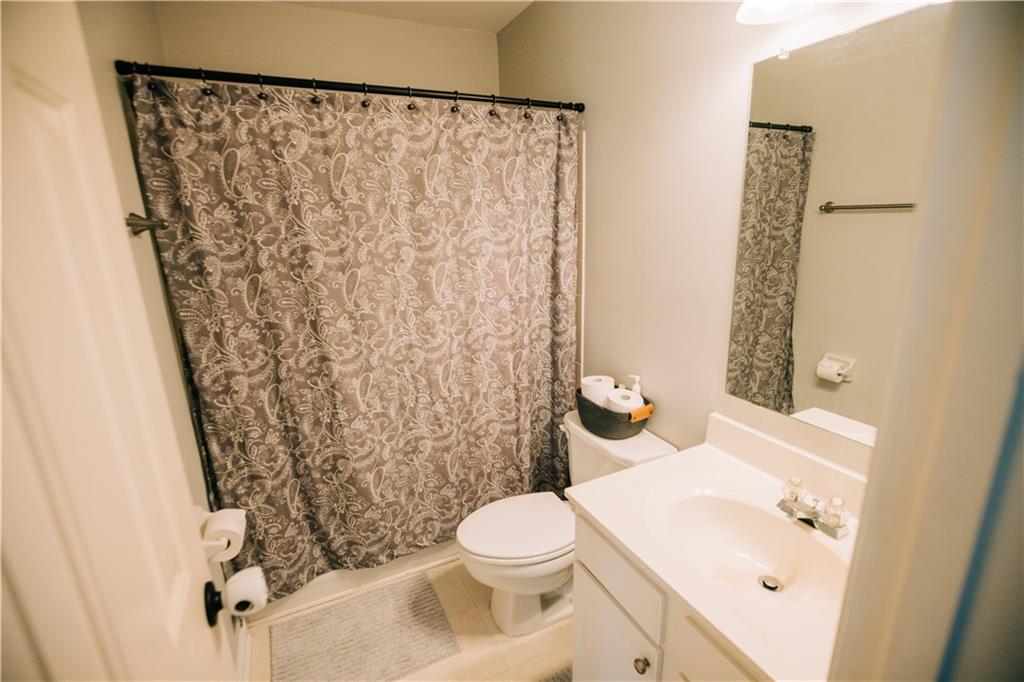 2533 Gold Hill Court Villa Rica, GA 30180 - Photo 34 of 46 a white toilet sitting next to a bathroom sink
