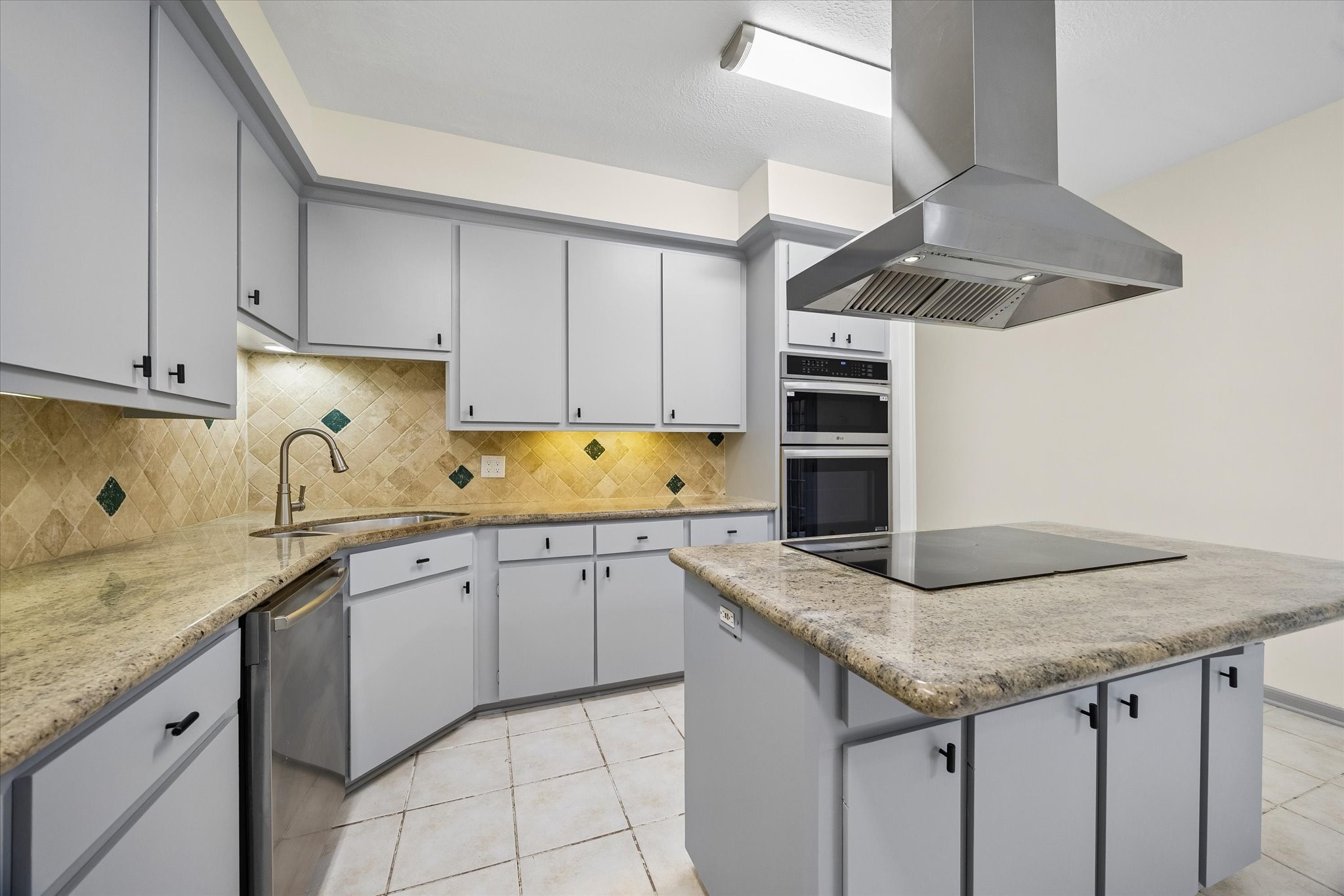 727 Bunker Hill Road, Unit 92 Houston, TX 77024 - Photo 12 of 50 KITCHEN IS GROUNDED BY AN ISLAND ELECTRIC COOKTOP.