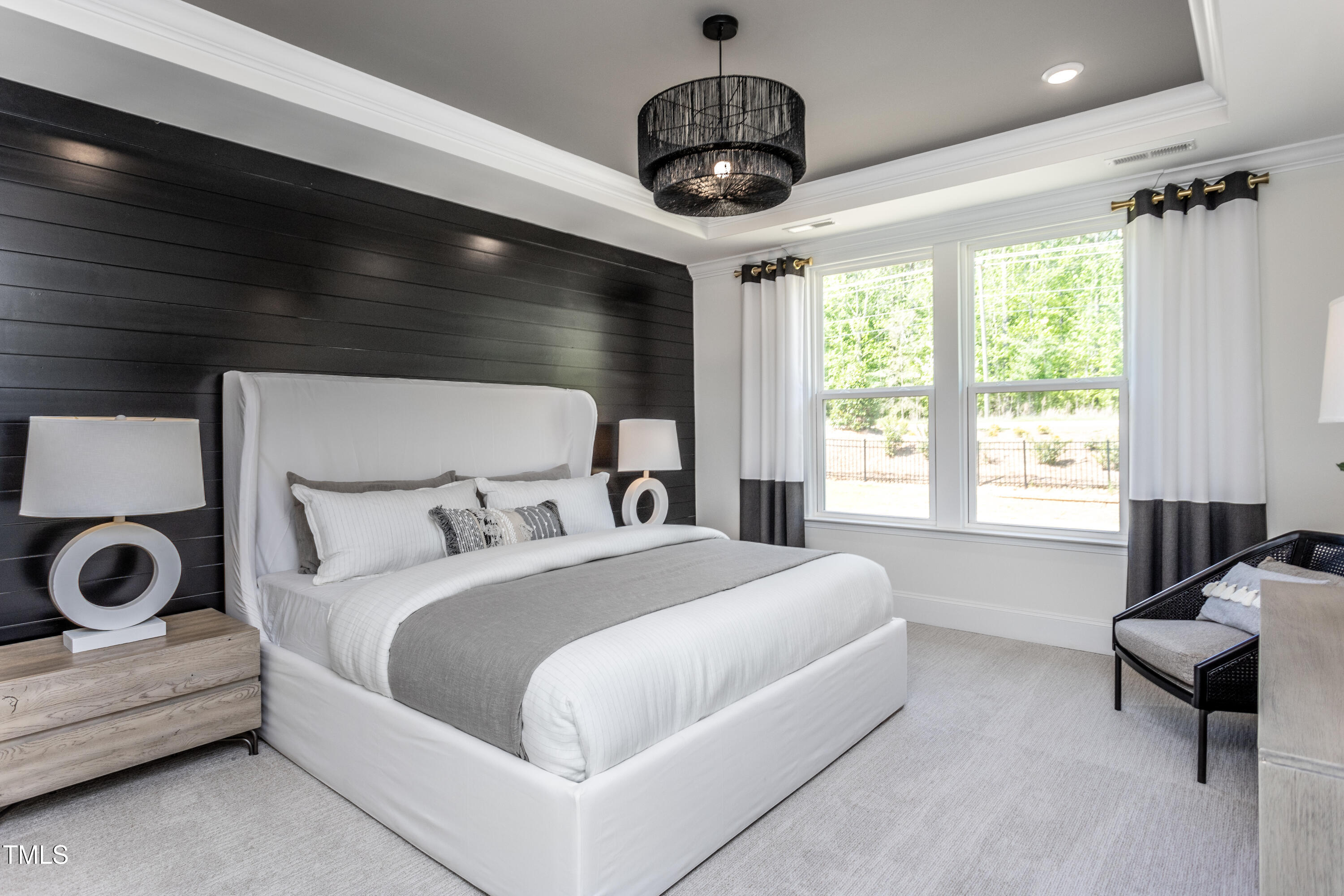 294 Arcadius Drive Clayton, NC 27520 - Photo 11 of 18 a spacious bedroom with a bed and a chandelier