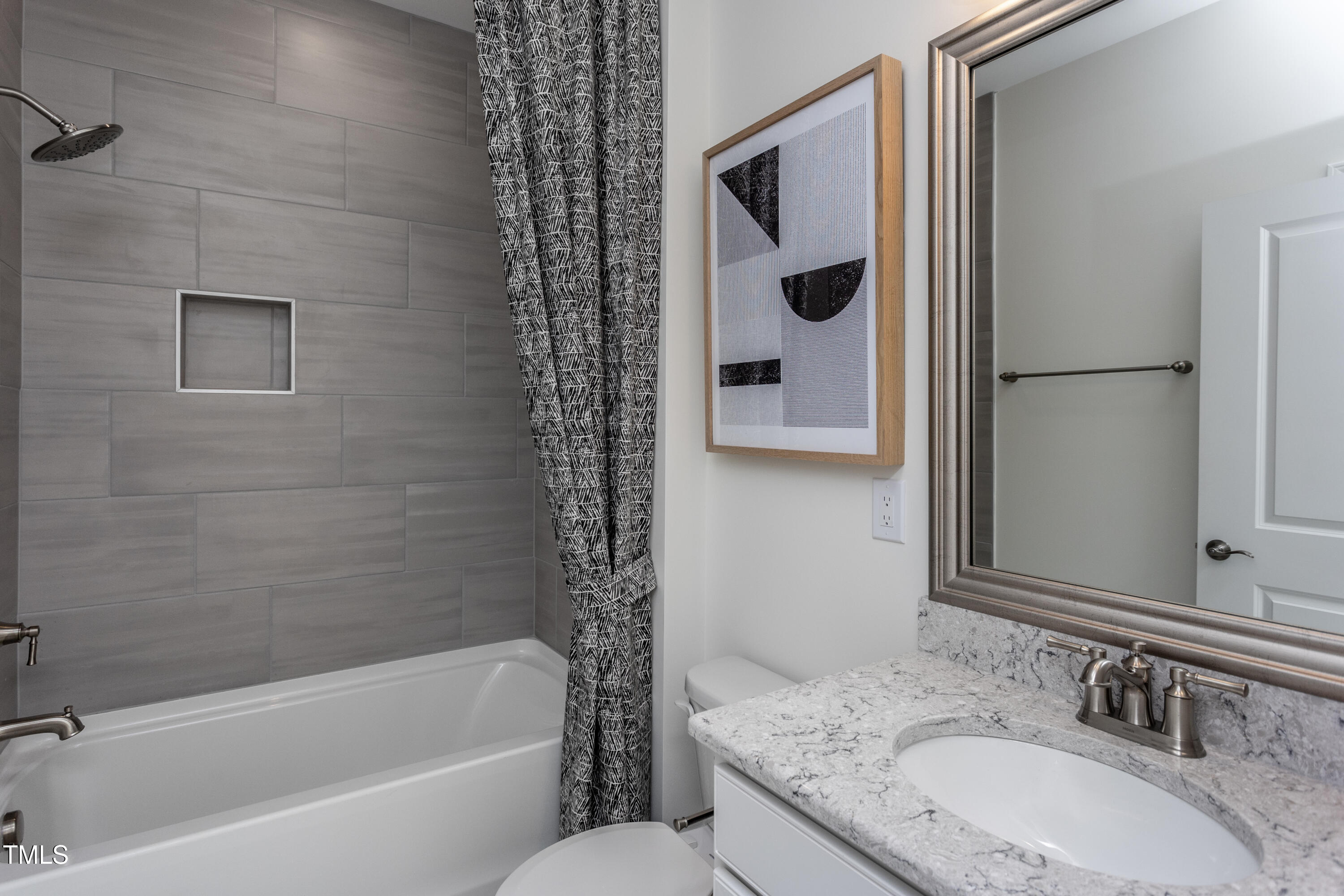 294 Arcadius Drive Clayton, NC 27520 - Photo 17 of 18 a bathroom with a granite countertop sink and a mirror