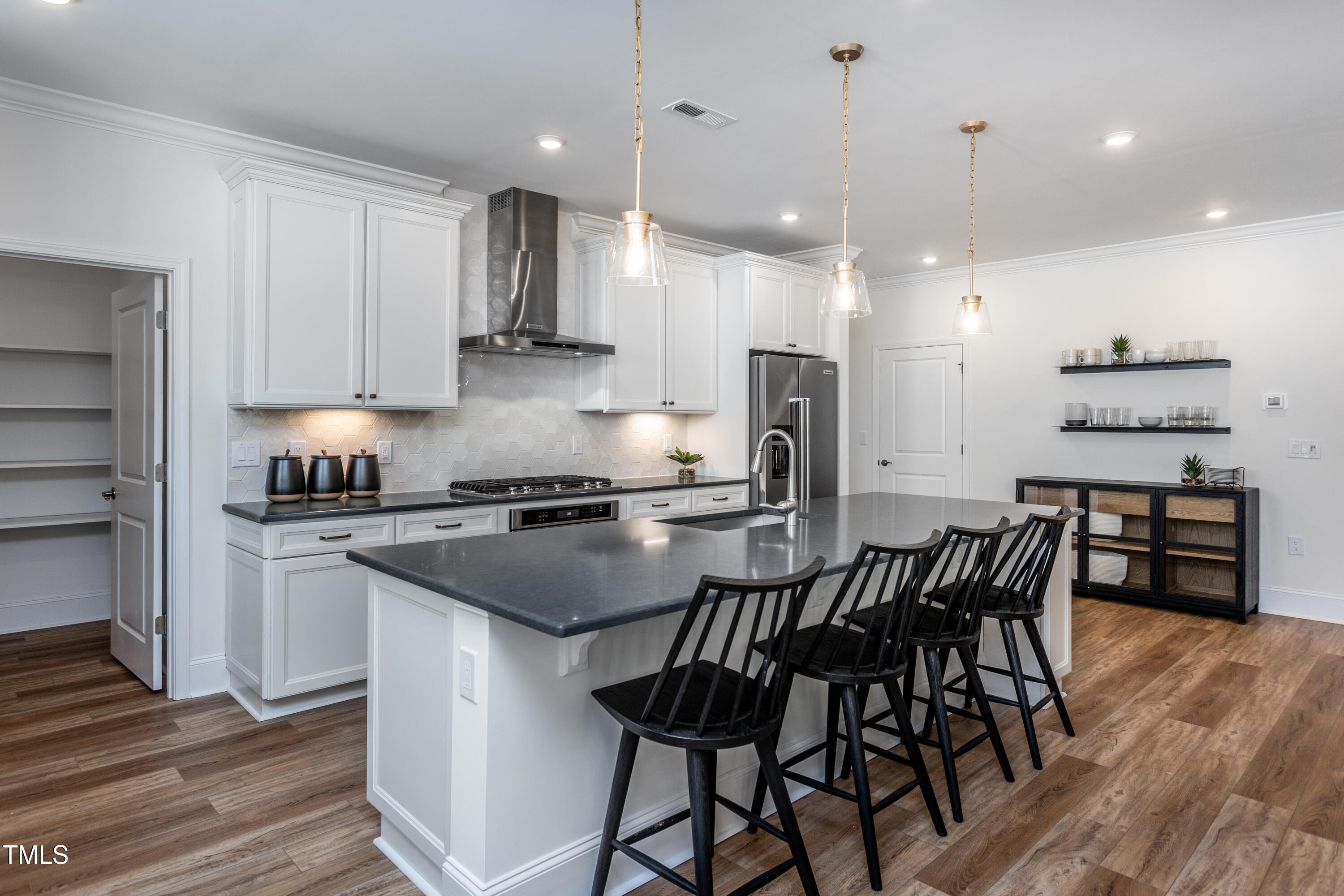294 Arcadius Drive Clayton, NC 27520 - Photo 5 of 18 a kitchen with stainless steel appliances granite countertop a stove a sink a refrigerator and a dining table with wooden floor