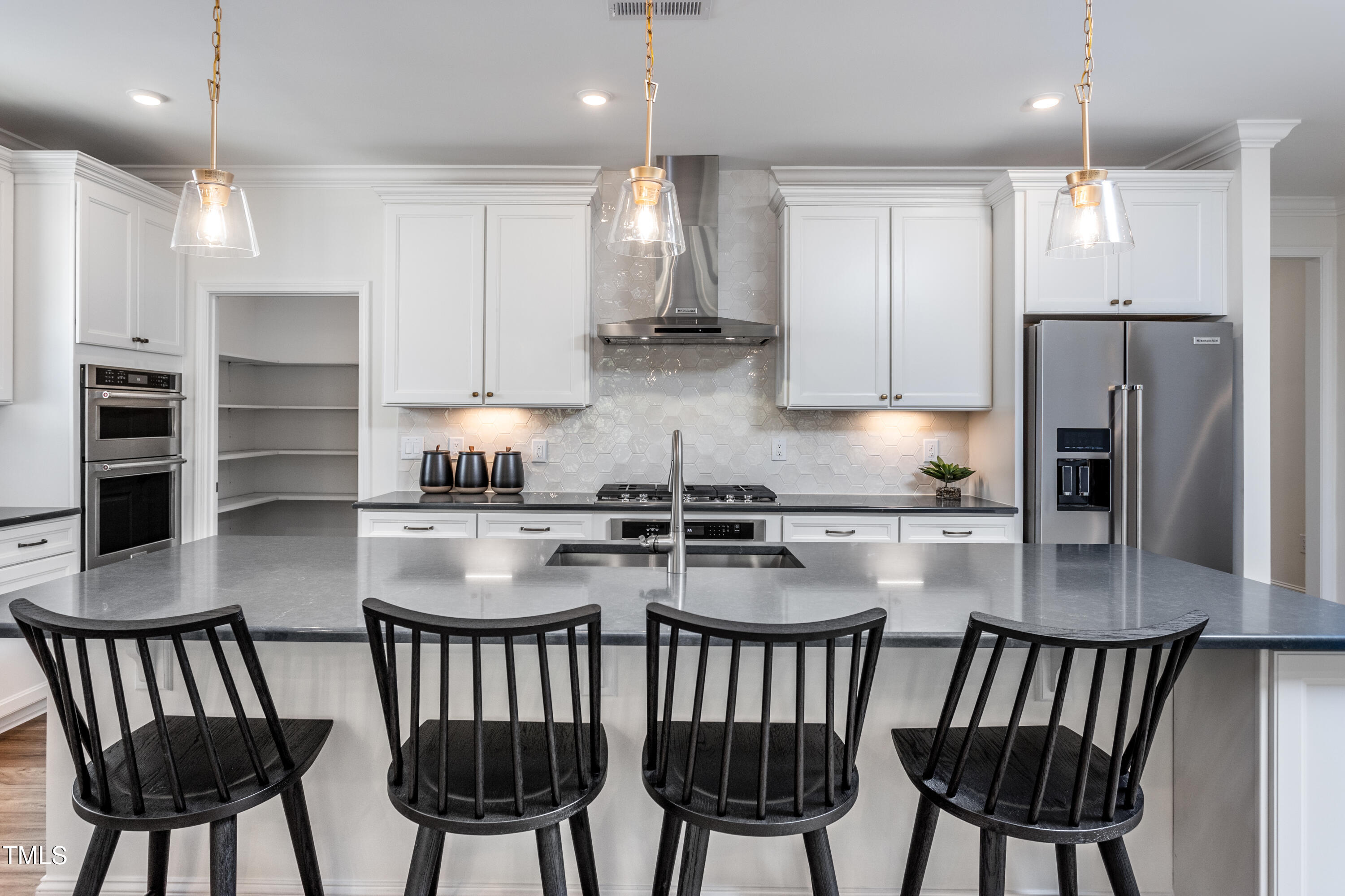 294 Arcadius Drive Clayton, NC 27520 - Photo 6 of 18 a kitchen with stainless steel appliances granite countertop a kitchen island a table and chairs