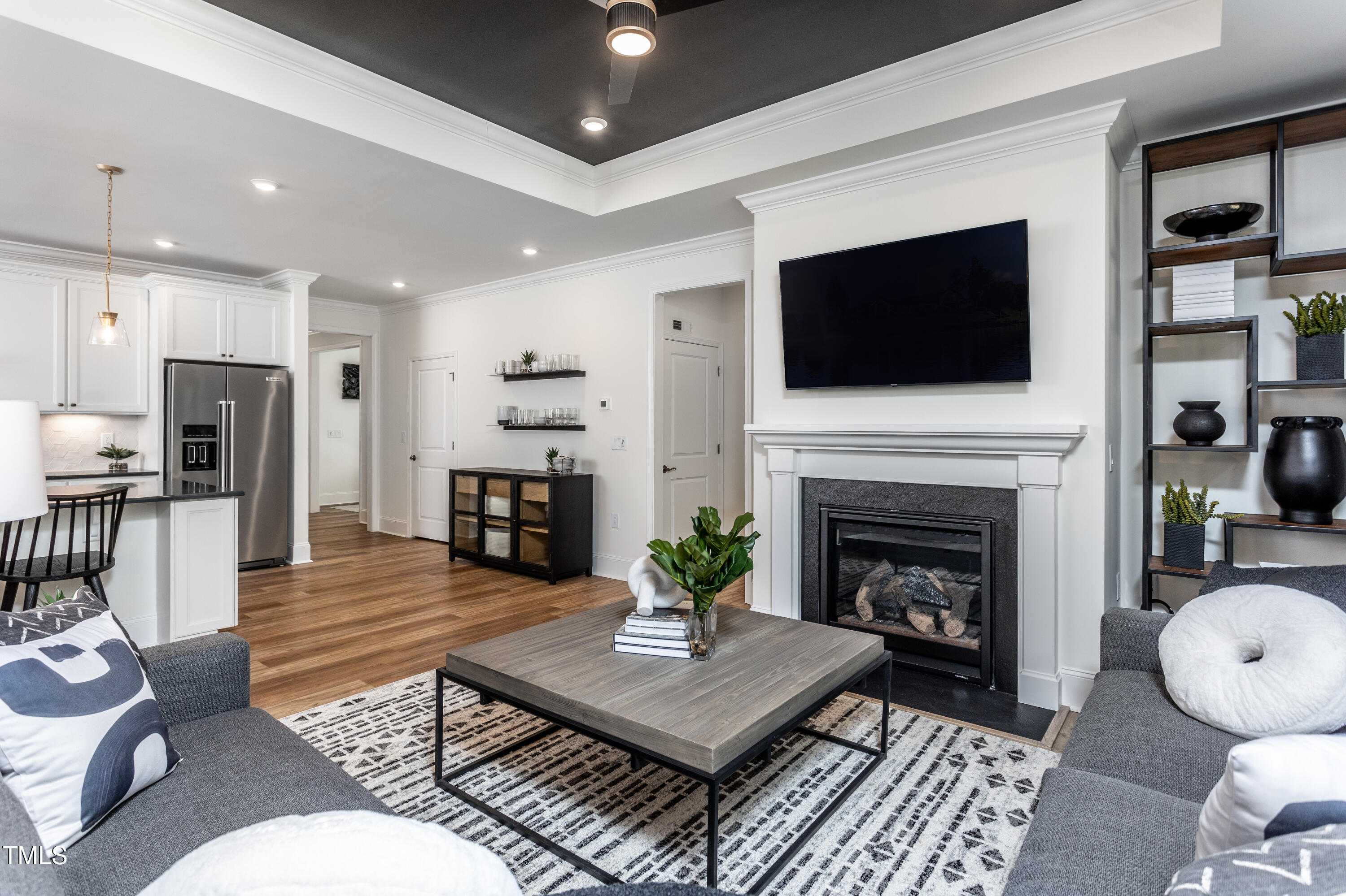 294 Arcadius Drive Clayton, NC 27520 - Photo 8 of 18 a living room with furniture a flat screen tv and a fireplace