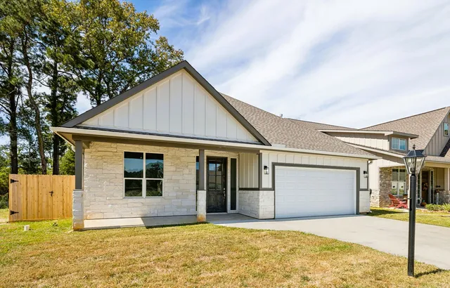 a view of a house with a backyard