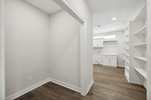 a view of a hallway with wooden floor
