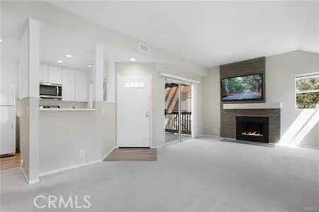 a view of a livingroom with an empty space and a fireplace