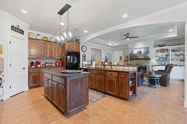 a kitchen with granite countertop a stove oven and a refrigerator