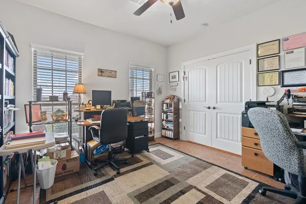 a view of a livingroom with workspace and a window