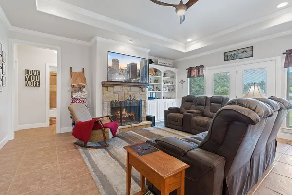 a living room with furniture a flat screen tv and a fireplace