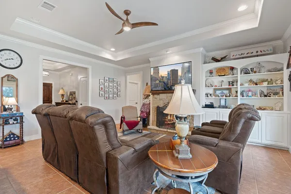 a living room with furniture and a chandelier