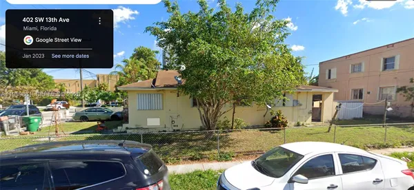 a view of a white house with a yard