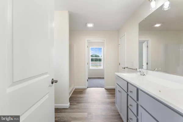 a bathroom with a sink a mirror and a bathtub