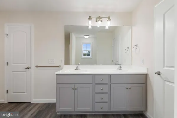 a bathroom with a double vanity sink and mirror