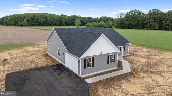 a aerial view of a house next to a big yard